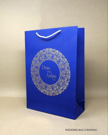 A stack of luxury paper bags custom-designed for Pintu & Ankita's wedding.