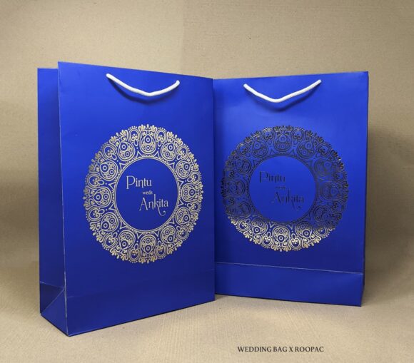Pintu & Ankita's luxury wedding paper bag with golden foil names.
