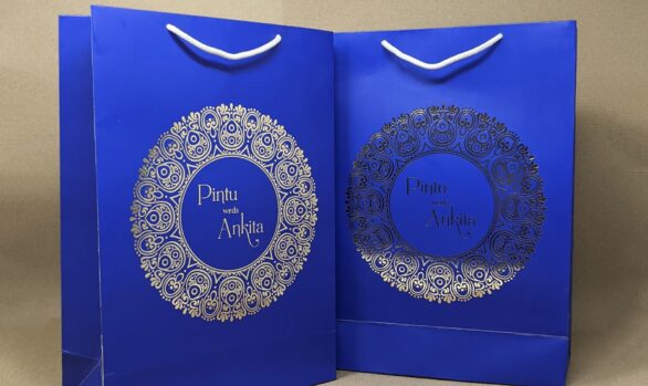 Pintu & Ankita's luxury wedding paper bag with golden foil names.