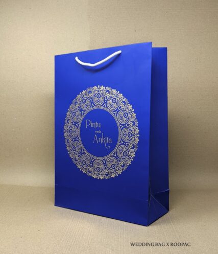 Wedding guests holding Pintu & Ankita's personalized luxury paper bag.