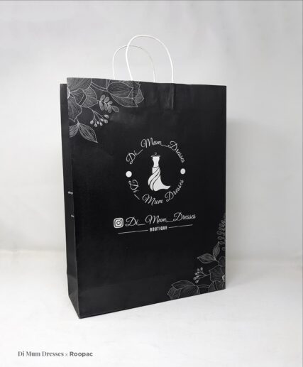 Shopper holding the eco-friendly Printed Paper Bag from Di Mum Dresses Boutique