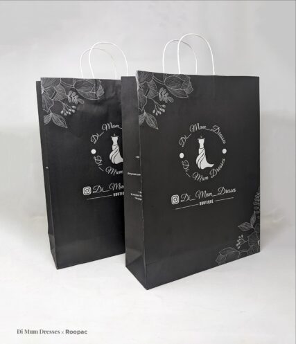 Printed Paper Bag from Di Mum Dresses Boutique, filled with fashionable dresses