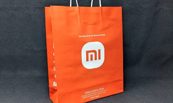Close-up view of the Xiaomi MI Mobile Store paper bag, showcasing the recognizable MI logo
