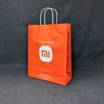 Spacious and durable Xiaomi MI Mobile Store paper bag, perfect for carrying your gadgets
