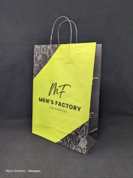 Fashion-forward man in Tiruppur carrying our stylish Branded Paper Bag from MF Men's Factory