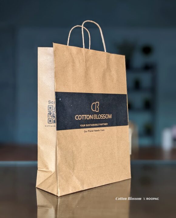A Brown Kraft Paper Bag with the Cotton Blossom logo, showcasing the brand's commitment to sustainability.