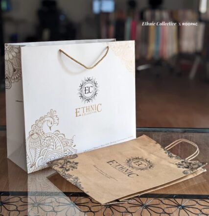 Ethinic Collective's customized paper bag with metallic gold logo, perfect for carrying your Parisian clothing finds
