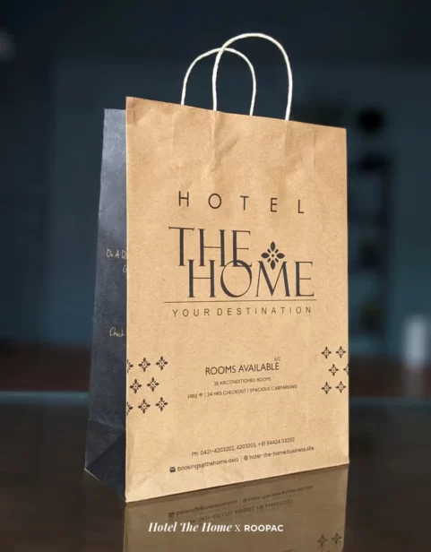 Guest holding a 'Hotel The Home' High-Quality Hotel Laundry Bag, crafted from recyclable paper