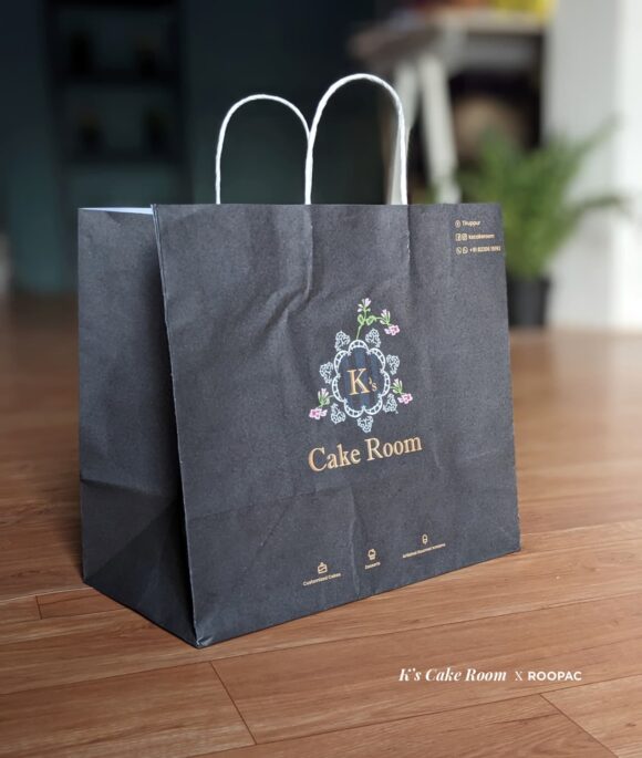 A high-quality paper bag with the logo of K's Cake Room, specifically designed for carrying and storing cakes