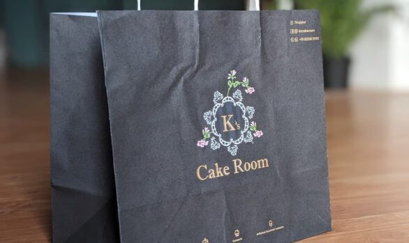 A high-quality paper bag with the logo of K's Cake Room, specifically designed for carrying and storing cakes