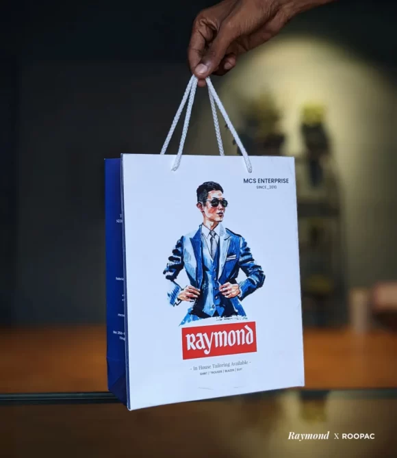 A sleek and sustainable Raymond paper bag with the brand logo, exuding style and eco-consciousness