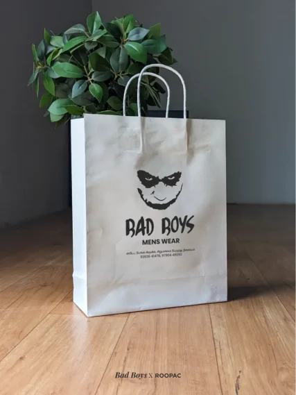 White paper bag with Bad Boys Menswear's black logo, by Roopac in Cuddalore District