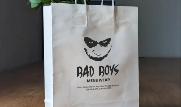White paper bag with Bad Boys Menswear's black logo, by Roopac in Cuddalore District