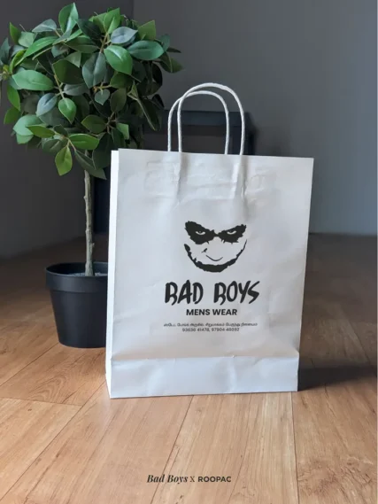 White paper bag with Bad Boys Menswear's black logo, by Roopac in Cuddalore District