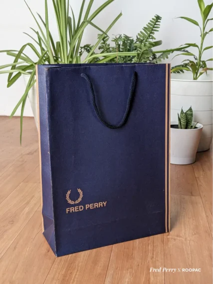 Fred Perry paper bag with blue Denim texture design, made from durable brown kraft, with Fred Perry logo, Original Since 1952, UK. bag made from Roopac, India