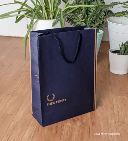 Fred Perry paper bag with blue Denim texture design, made from durable brown kraft, with Fred Perry logo, Original Since 1952, UK. bag made from Roopac, India
