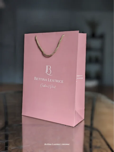 Bettina Leatrice pastel pink paper bag with white logo from Coimbatore.