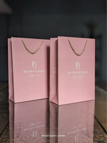 Elegant paper bag by Bettina Leatrice featuring a gold metallic rope handle.