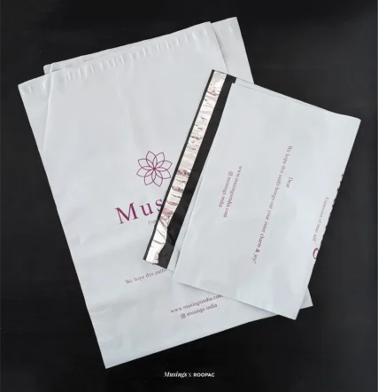 Musings white poly mailer with purple logo