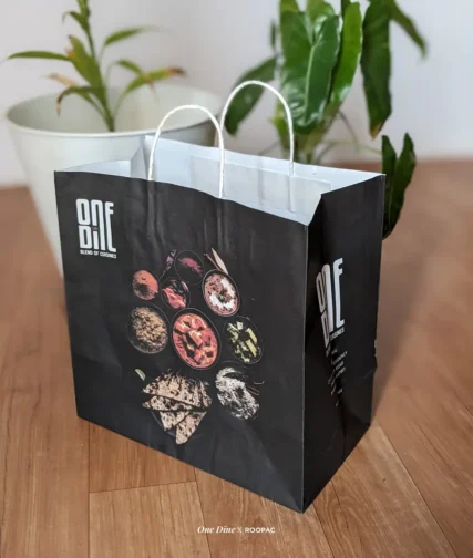 Close-up of One Dine Restaurant's signature paper bag