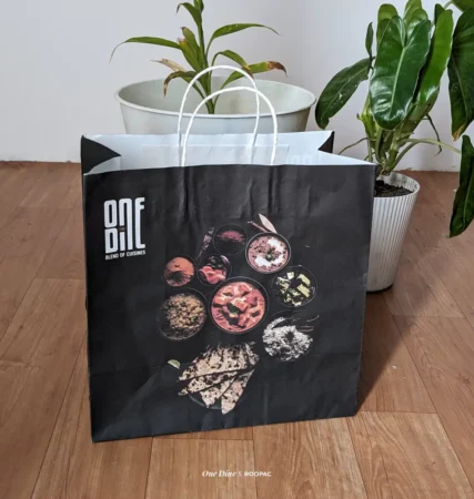 One Dine Restaurant's logo printed on paper bag