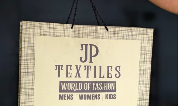 JP Textiles' fashionable light yellow and grey paper bag with thread pattern.