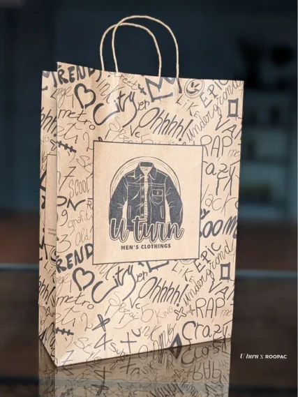 Strong brown paper bag with carrying handle for fashion retail.