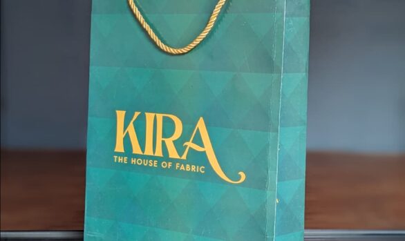 Dark blue paper bag with gold Kira logo for fabric store