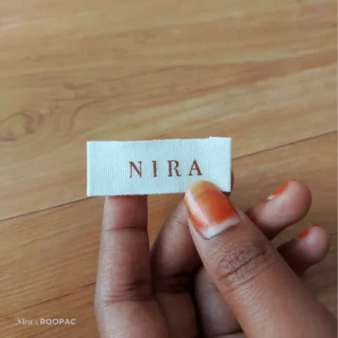 Nira's soft clothing label on a colorful designer kurti