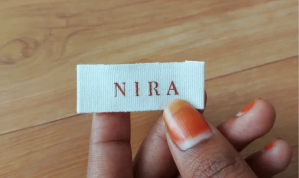 Nira's soft clothing label on a colorful designer kurti